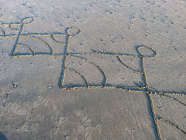 dessins éphémères sur le sable mouillé à marée basse
